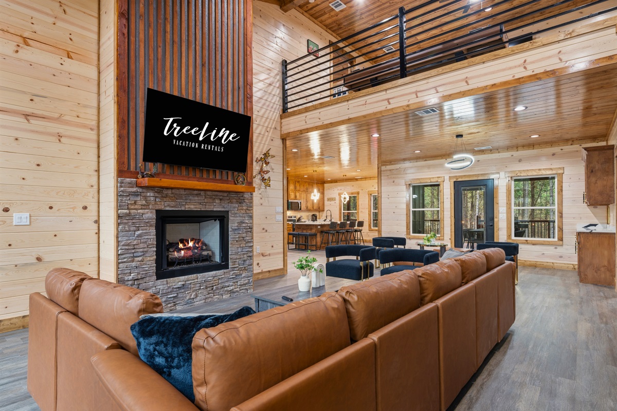 Cozy leather seating surrounds the fireplace and TV, creating the perfect place to relax with a movie or share stories late into the evening.