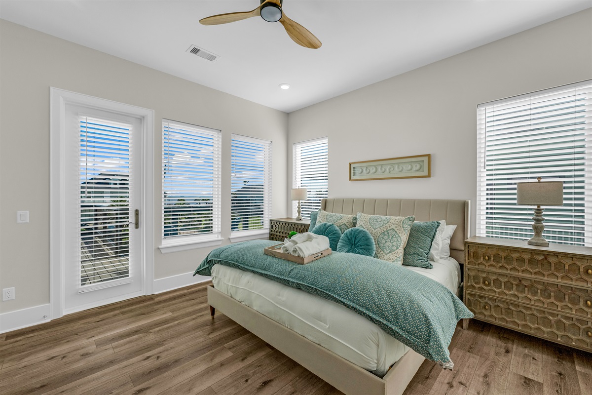 Costa Cristal Primary Bedroom: Unwind in a luxurious king bedroom, bathed in natural light and thoughtfully designed for comfort. Expansive windows frame breathtaking ocean views, creating a serene retreat.