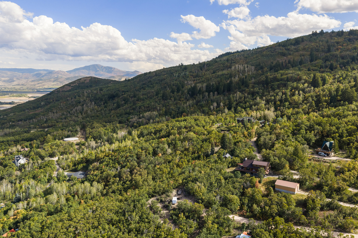 Expansive mountain and forest scenery surrounding the Nordic by Nature retreat.