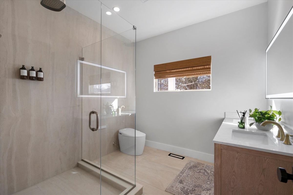 First floor bedroom bath with rain shower and heated towel rack. 