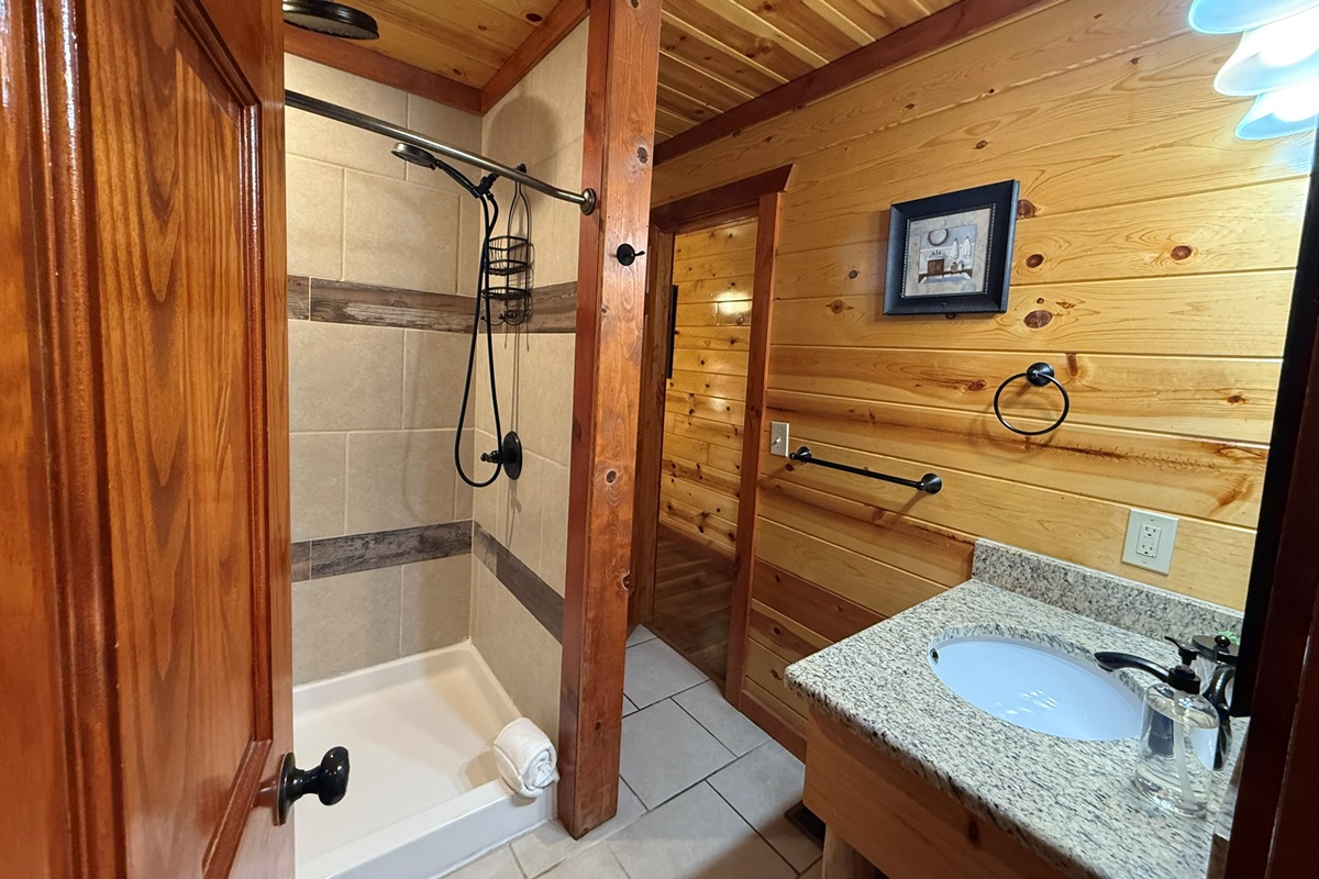 Perfectly positioned ensuite bathroom featuring a spa-like shower with luxurious dual rainfall showerheads.