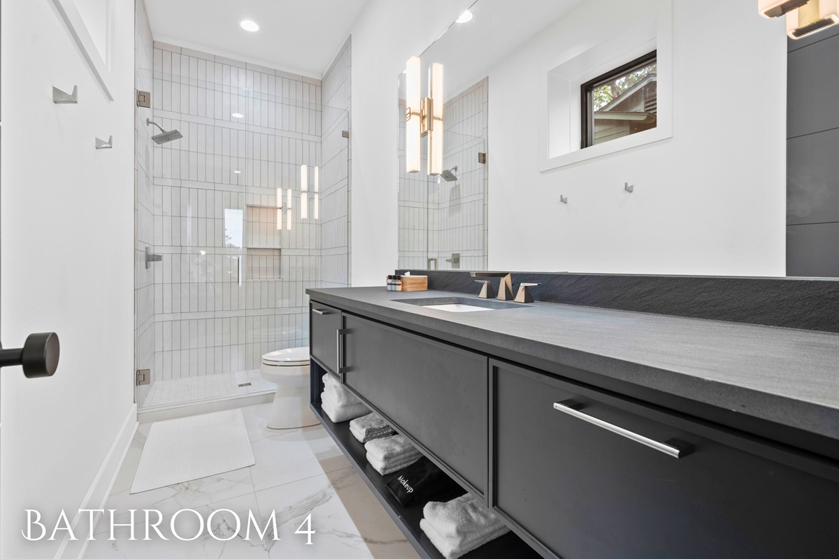 Enjoy a spa-like experience in this beautifully designed bathroom, complete with modern finishes and ample space.