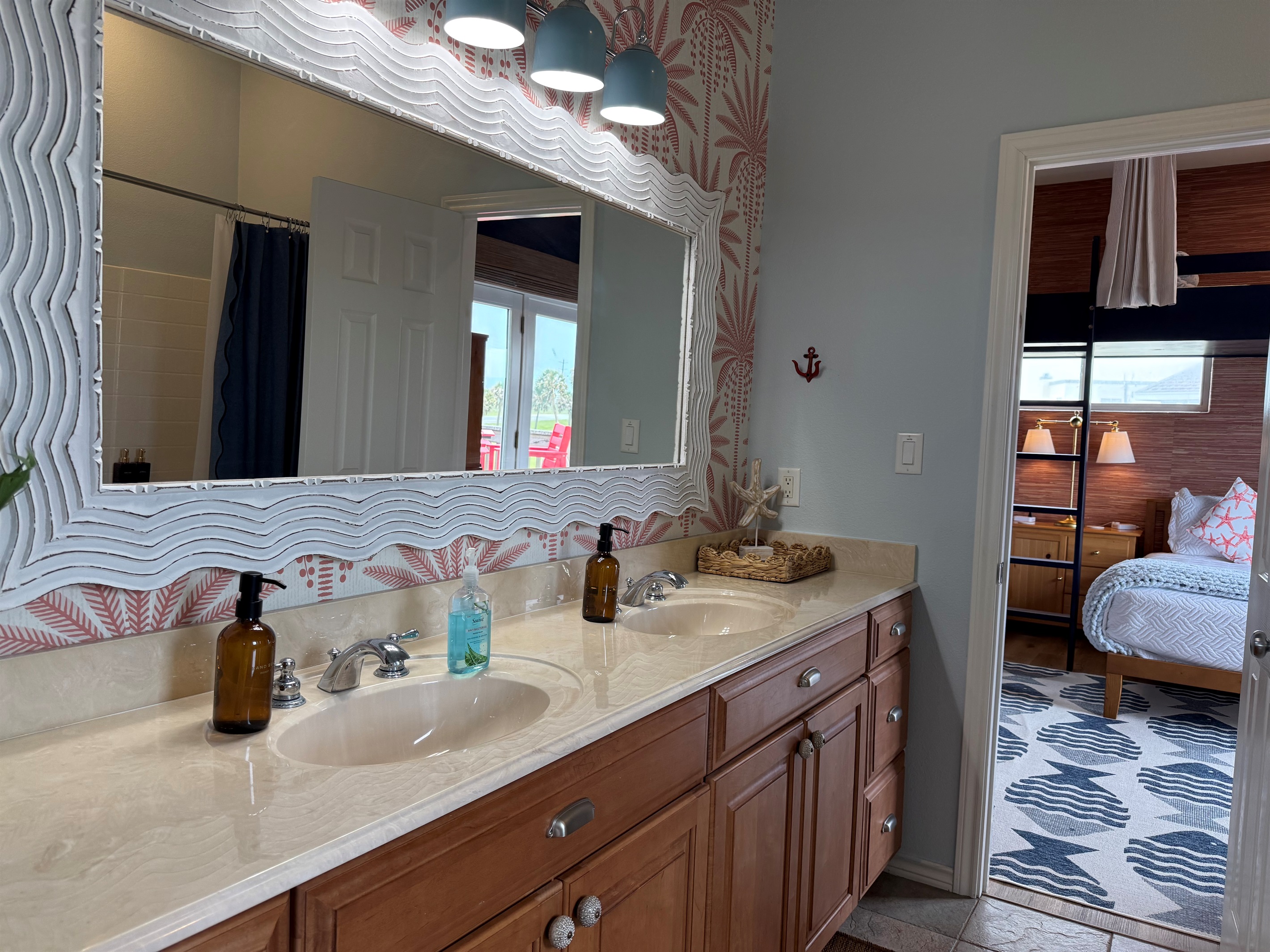 Double vanities and tub shower combo with plenty of towel hooks in the Hollywood Bathroom. 