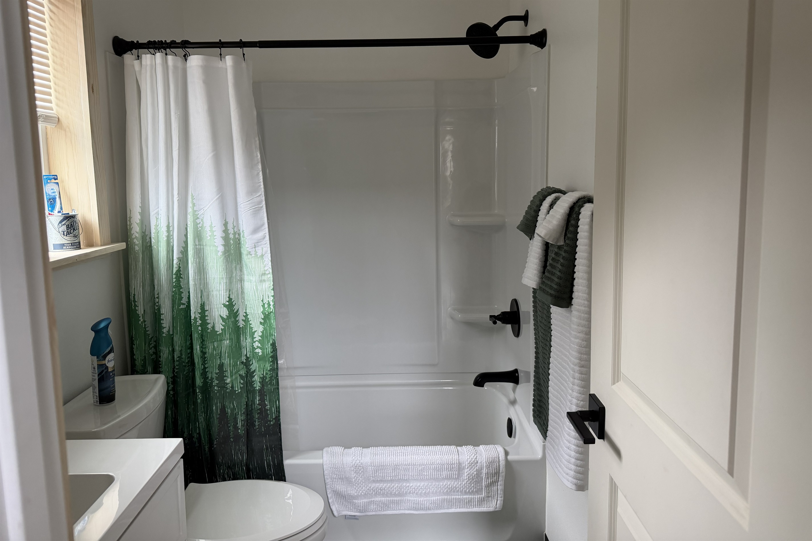 Full bath with vanity, toilet, and tub/shower combo.