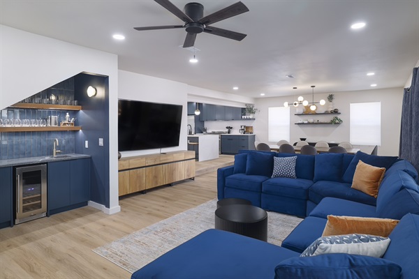 Bright, spacious retreat with a stylish blue sectional and bar for entertaining!