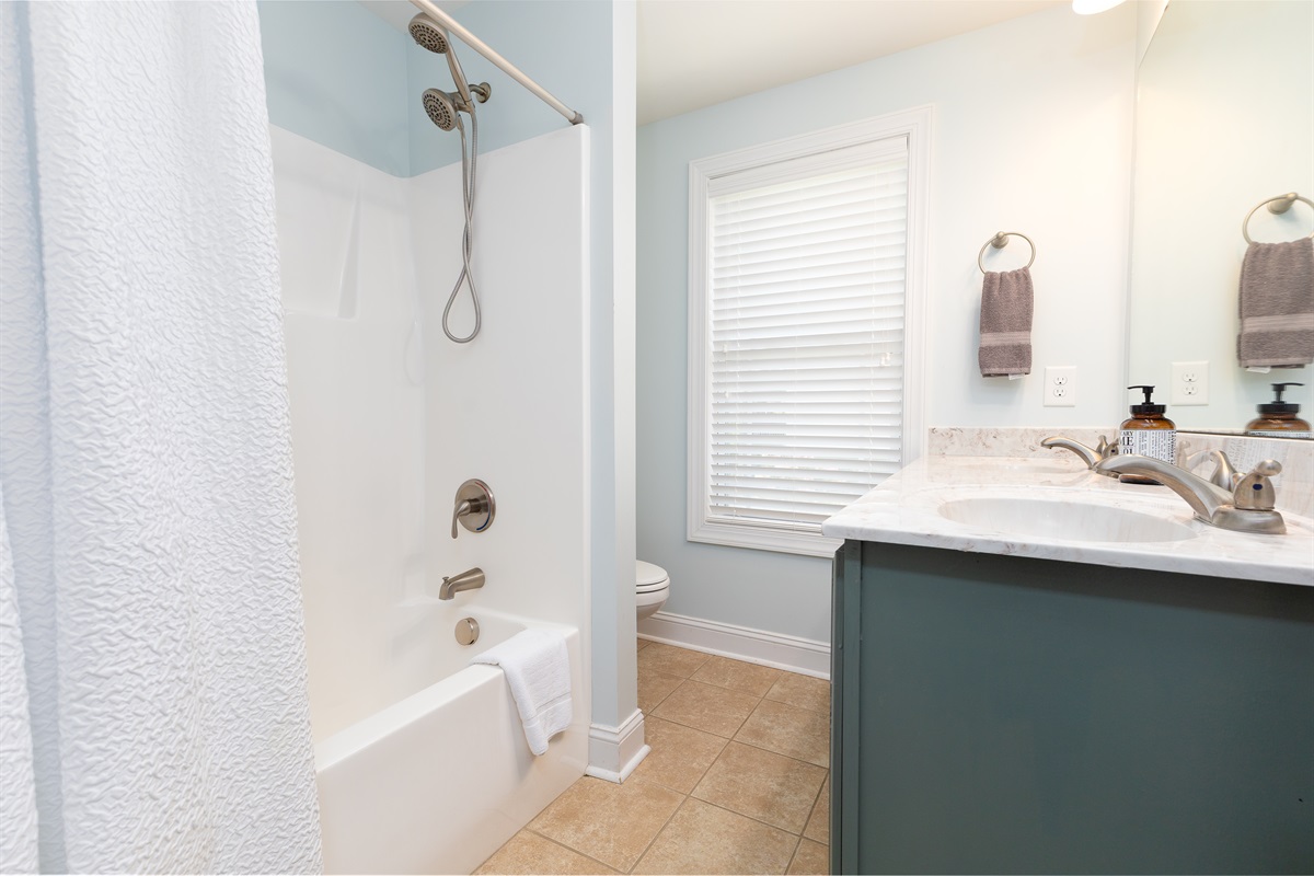 3rd bathroom offers a tub/shower combo and modern vanity