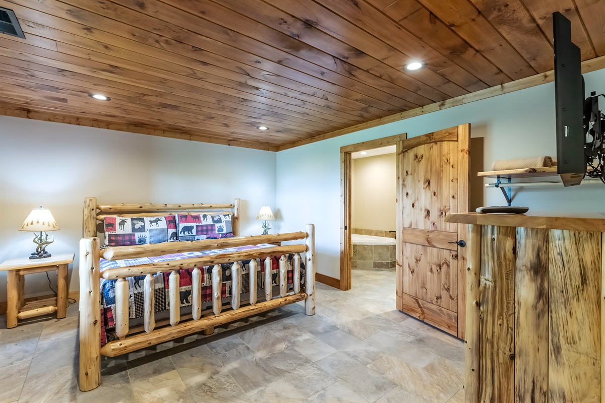 The lower level bedroom has a king-sized bed, an ensuite bathroom and personal TV.