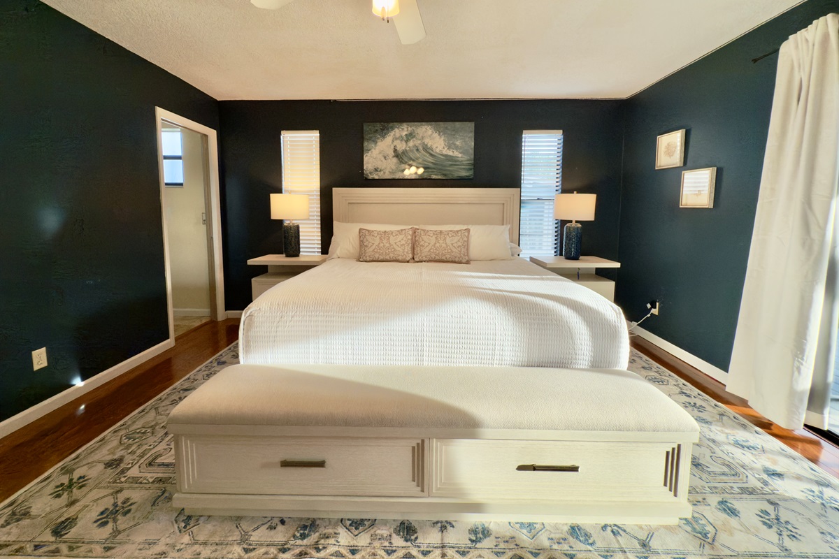 Twin windows frame each side of the bed, letting in natural light while maintaining privacy.
