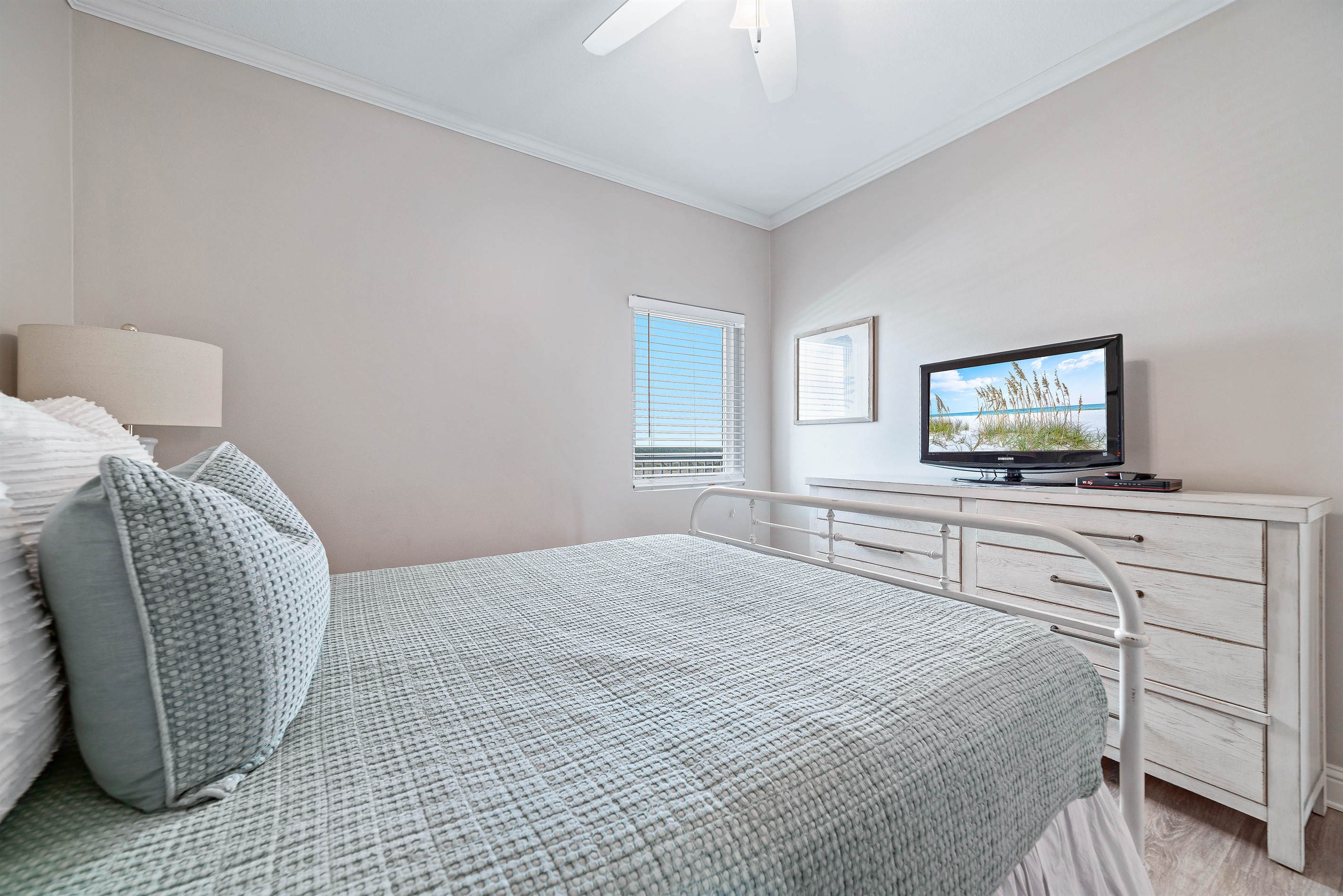 Light and airy guest bedroom with a classic white palette and elegant furnishings, creating a calming atmosphere.
