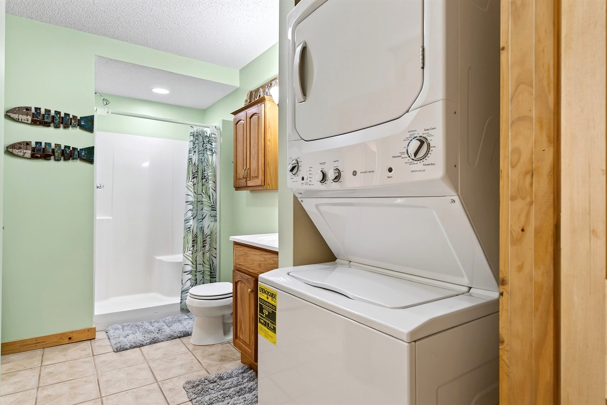 Jack and Jill bathroom with walk in shower and washer and dryer