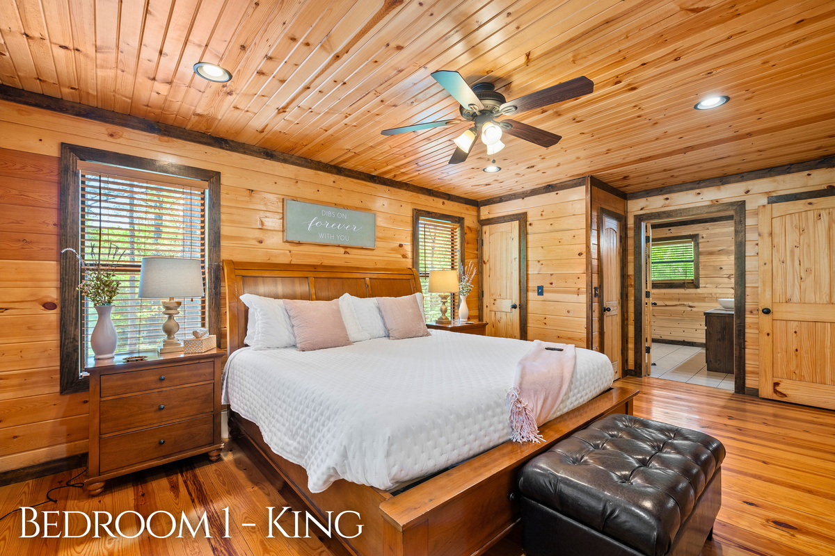 In Bedroom 1, a king bed, soft linens, and peaceful woodland views make sleeping in feel absolutely mandatory.