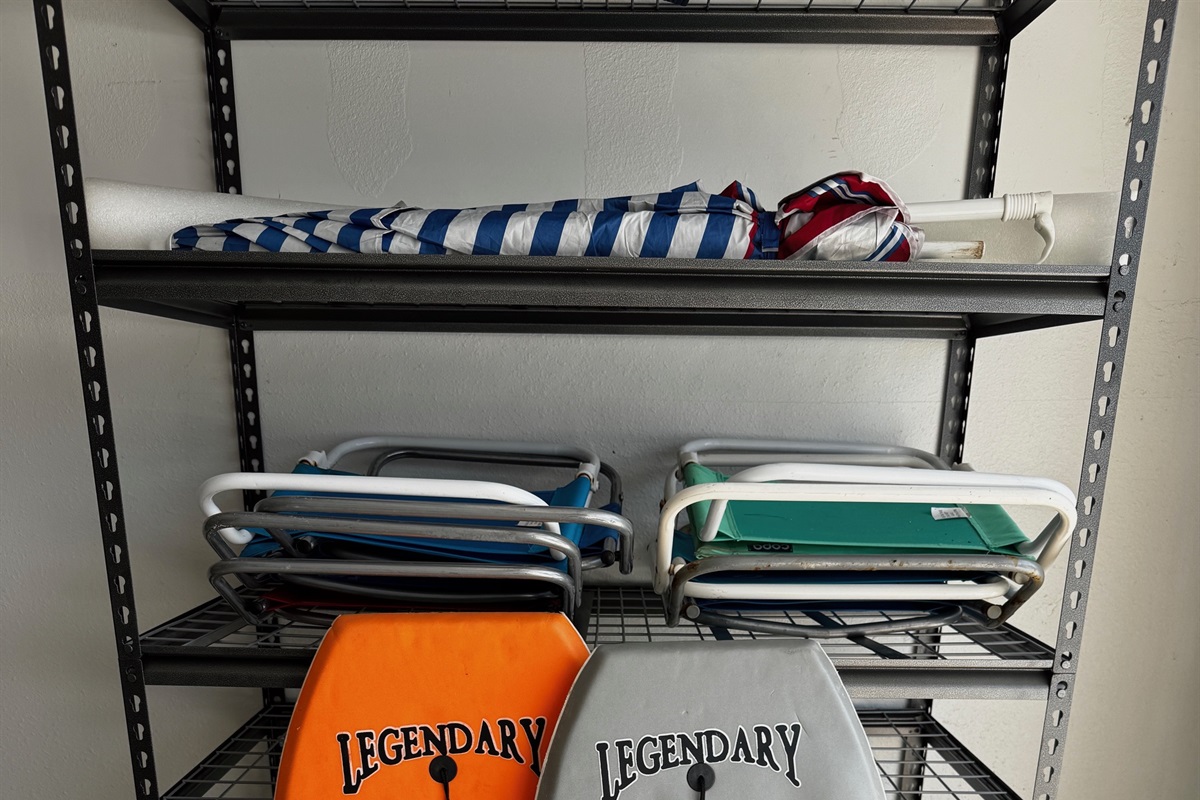 Beach chairs, umbrella & boogie boards