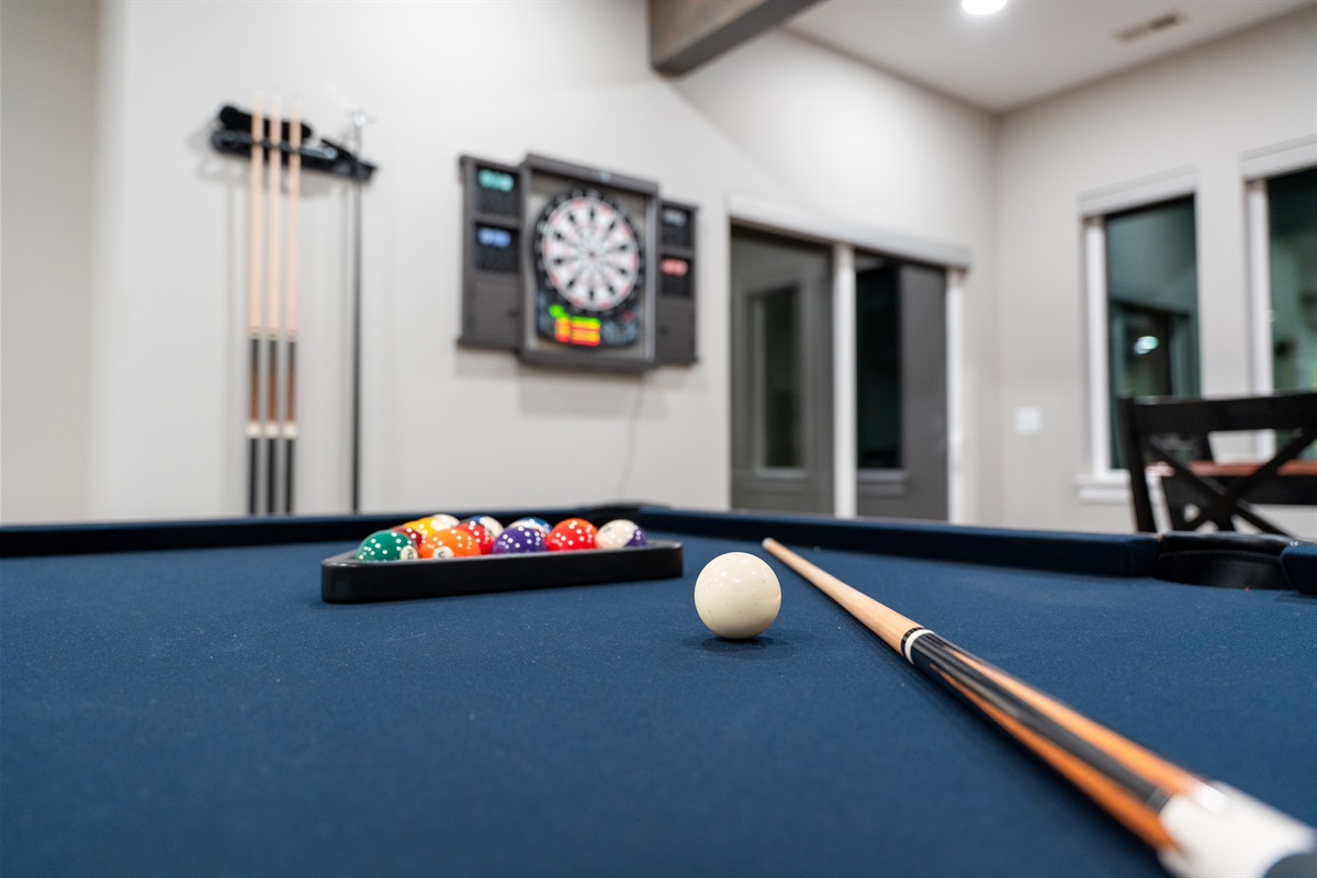 Spacious rec room with pool table, ideal for friendly competition and evening entertainment.