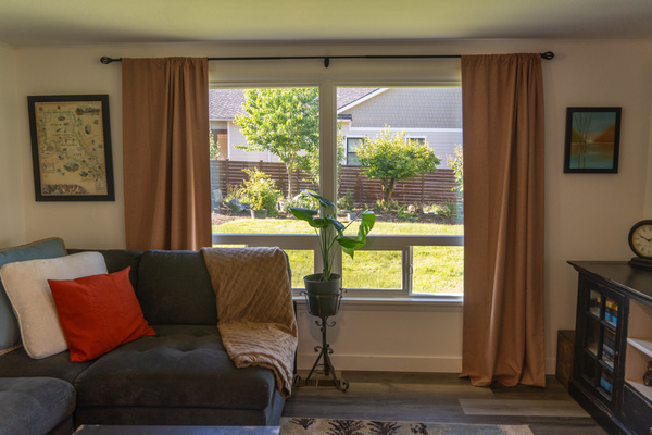 An oversized, inviting couch with plush pillows and throws offers the perfect spot to relax, unwind, and enjoy the view or a show.