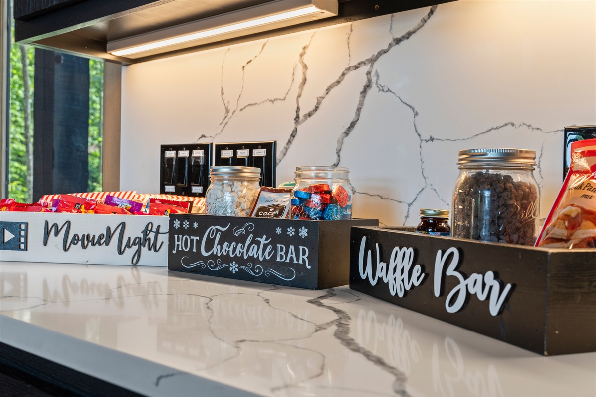 This fun snack station includes everything you need for the ultimate cozy stay: a Movie Night box full of treats, a Hot Chocolate Bar to warm your evenings, and a Waffle Bar perfect for sweet morning indulgence. A delightful touch!