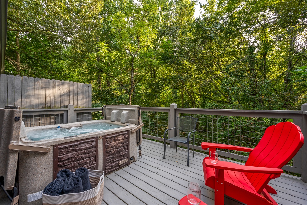 Unwind in your private hot tub amidst serene mountain greenery. Pure relaxation!