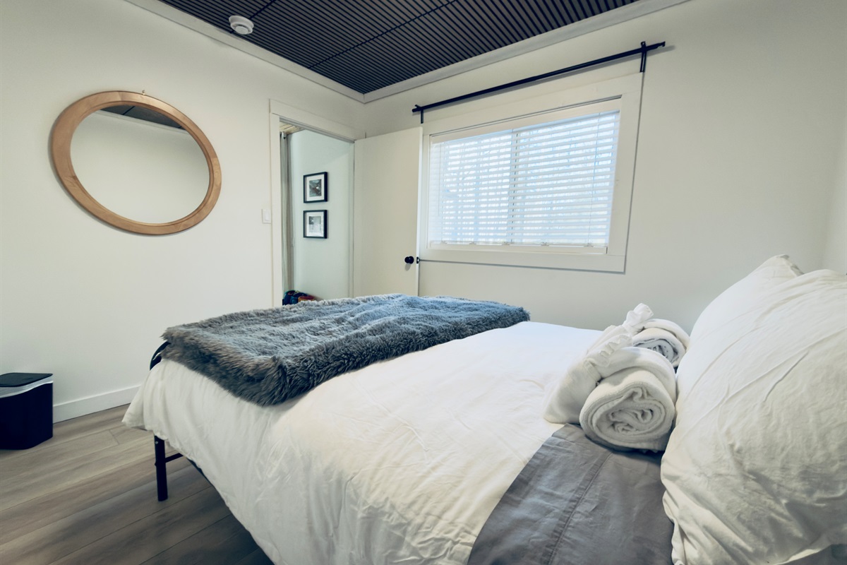 Queen bedroom with cozy bedding and relaxing atmosphere