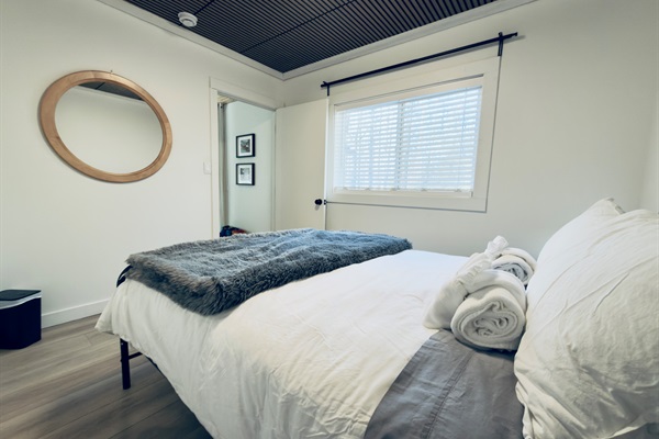 Queen bedroom with cozy bedding and relaxing atmosphere