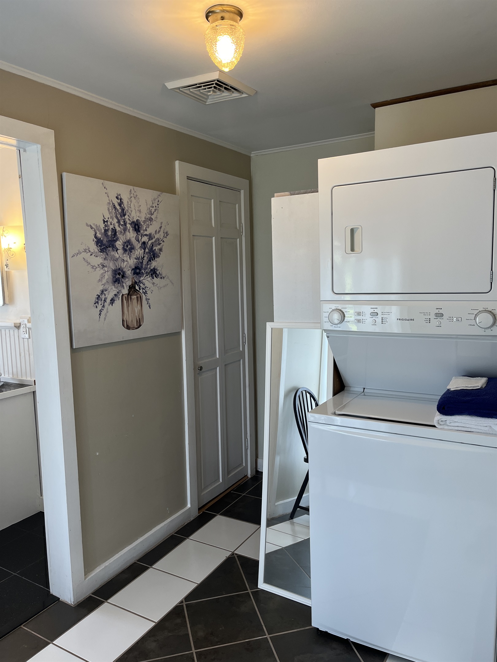 Laundry between entryway and bathroom