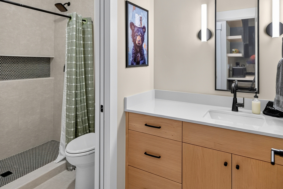 This bathroom is accessible from the family room and second primary suite.  It includes a pocket door to the wet room so someone can shower and another person can get ready for a day in nature!