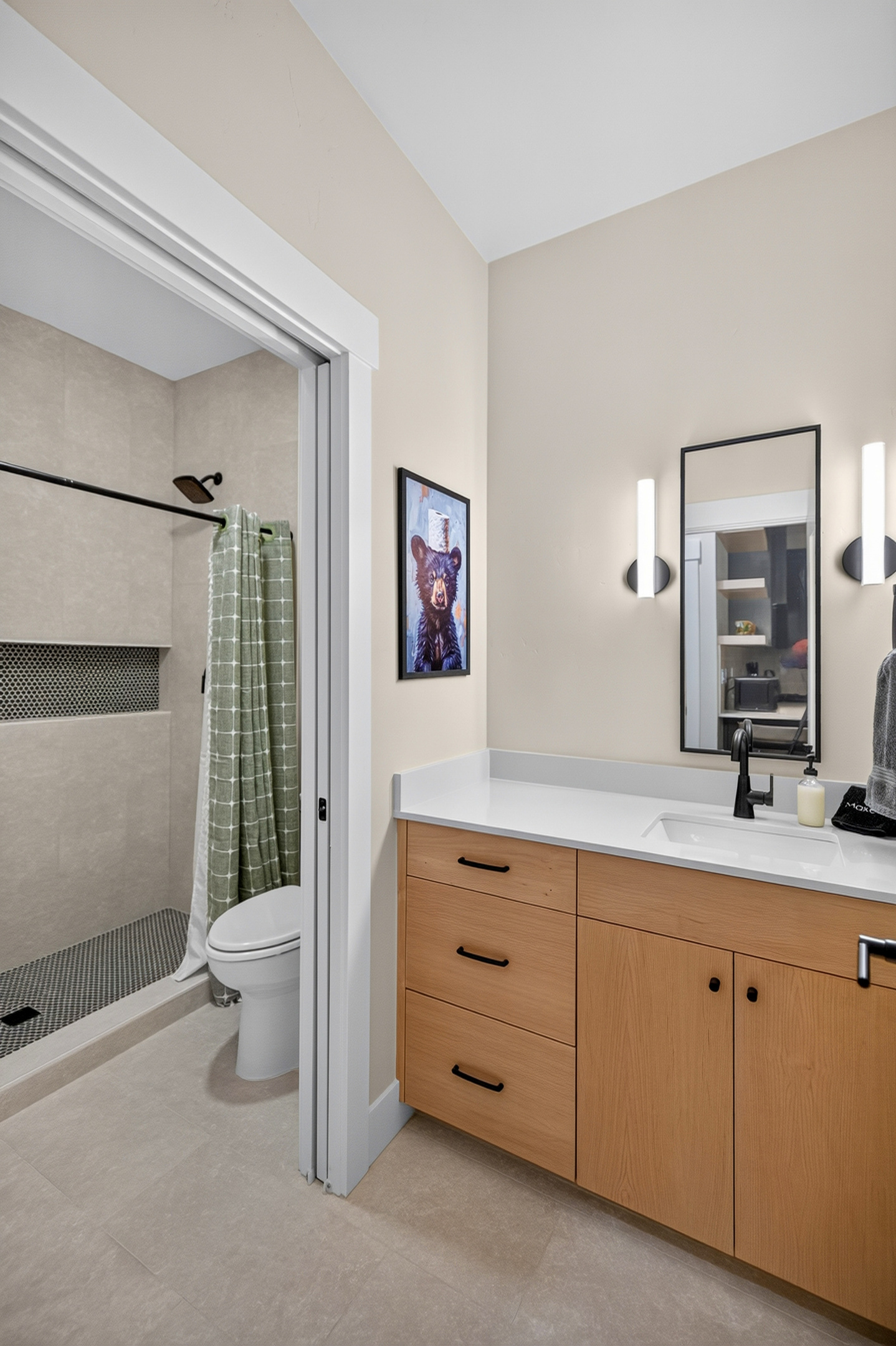 This bathroom is accessible from the family room and second primary suite.  It includes a pocket door to the wet room so someone can shower and another person can get ready for a day in nature!
