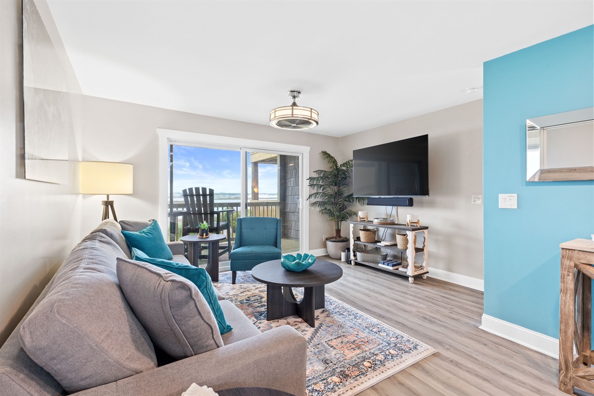 Bright coastal living with balcony access and sound views just beyond the glass