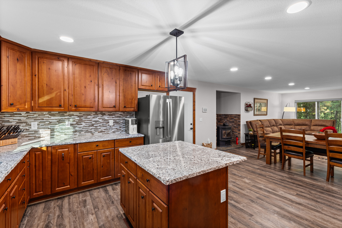 Kitchen with oven, island and refrigerator