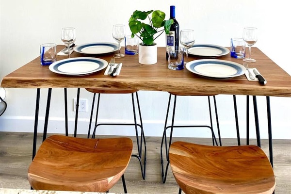 Your dining table is just across from the kitchen island.  Seats four comfortably or  you can choose to dine on the balcony all the same :)