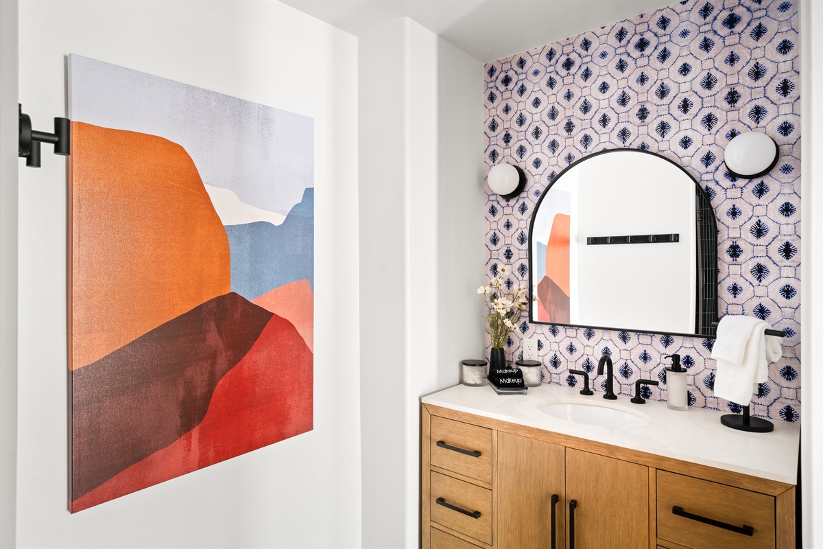 Modern bathroom with vibrant tiles, spacious tub & shower, and elegant vanity for a relaxing stay!