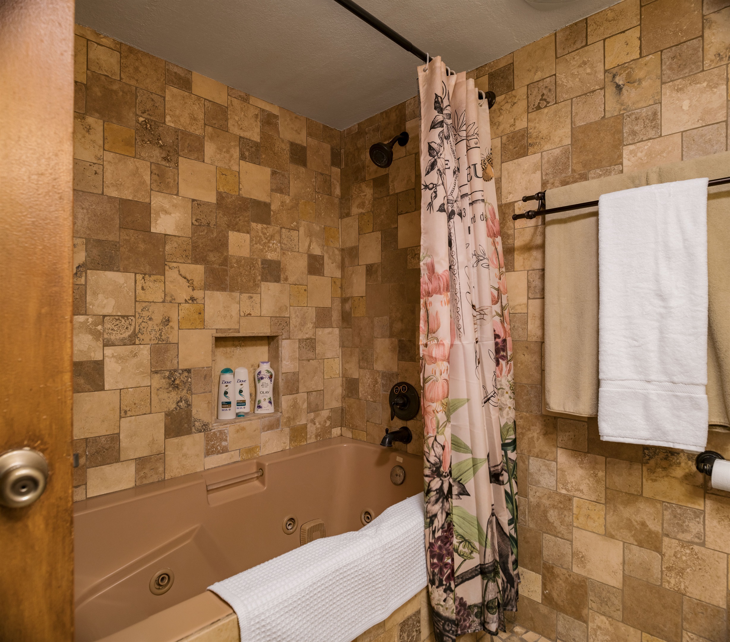 Slip behind the floral curtain into a romantic jetted tub perfect for evening unwinds and candlelit soaks.
