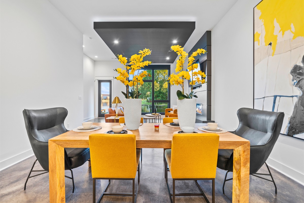 A closer look at the dining area, where sleek furniture and colorful touches create a warm and welcoming atmosphere.