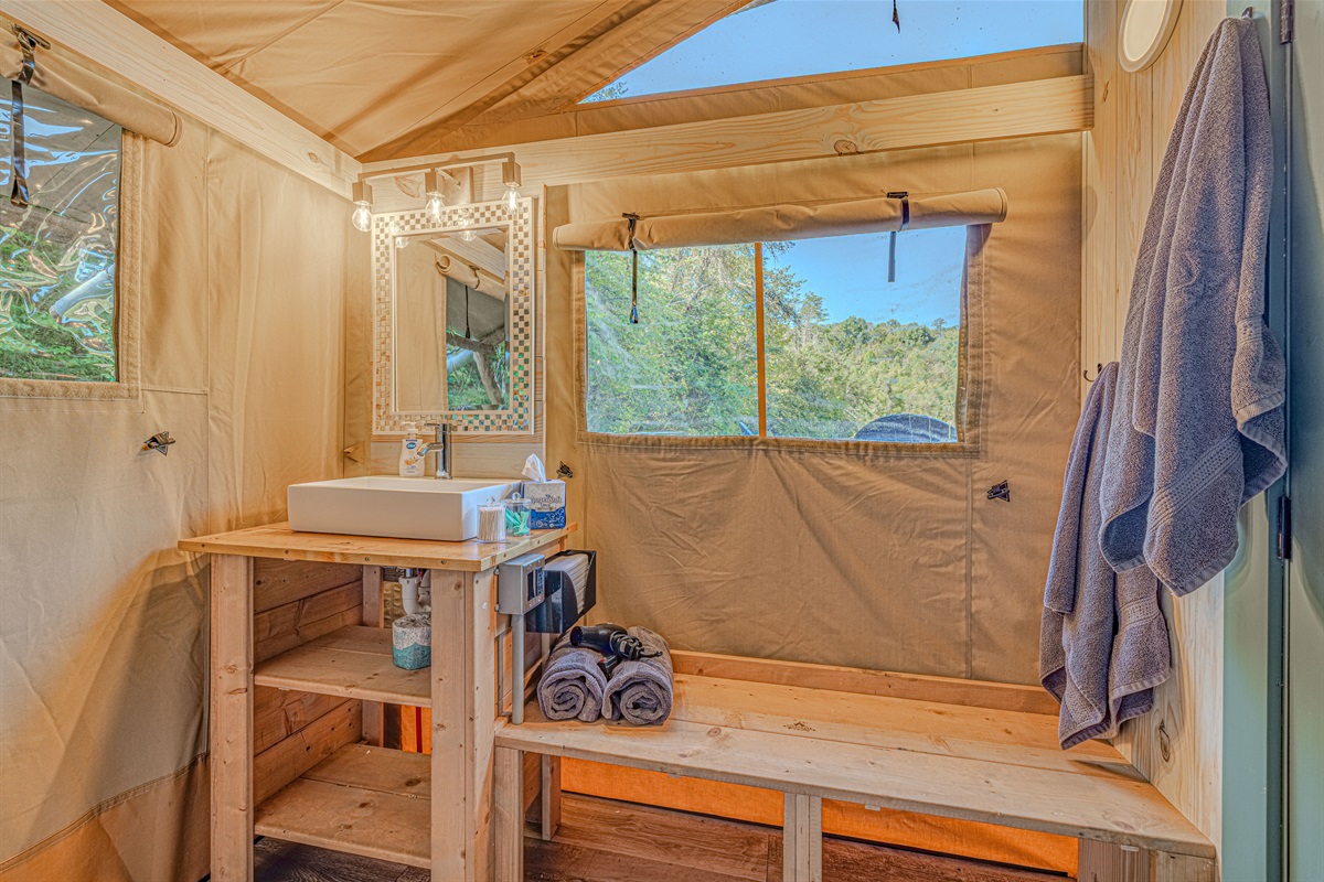 Modern touches in a natural setting. This private bath cabinet features everything you need to feel refreshed, proving that you don't have to sacrifice comfort when you camp with us.