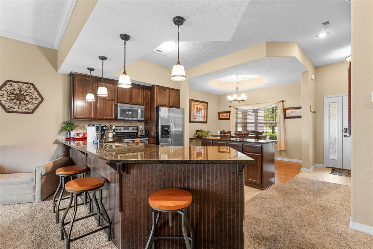The kitchen island adds extra seating and keeps the cook connected to the rest of the group.