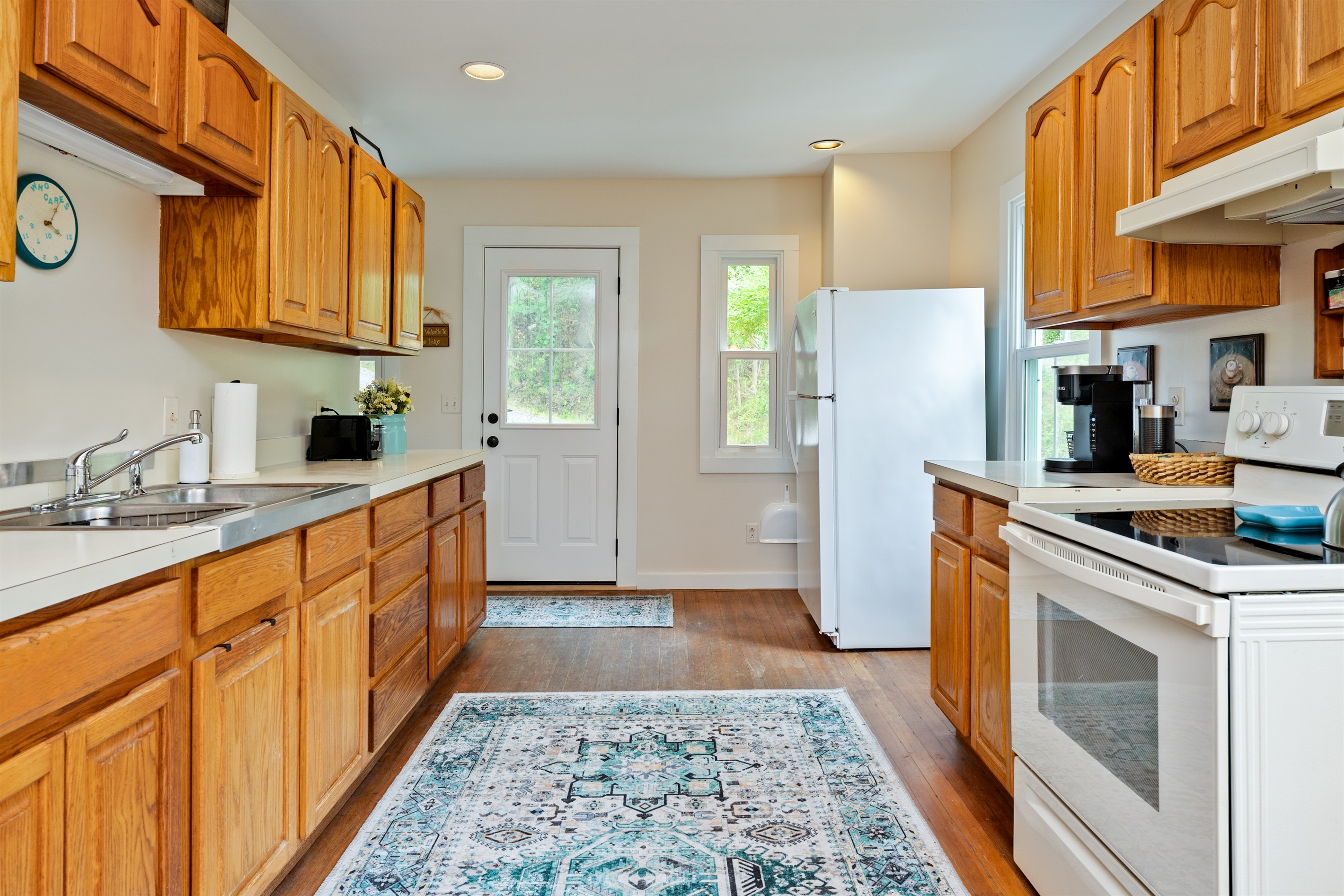 Spacious galley kitchen featuring ample counter space, updated appliances, and plenty of storage, ideal for cooking and entertaining.