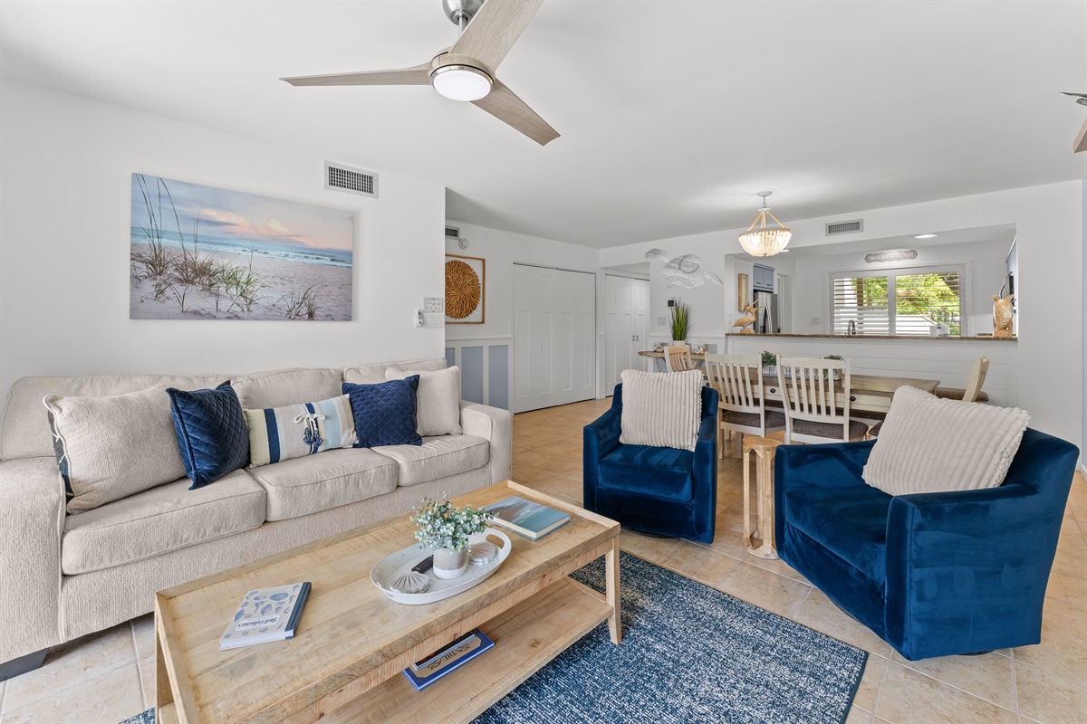 Spacious open Living room with fireplace, large TV and deck access.