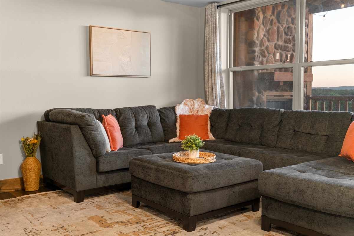 Cozy living room with sectional and smart TV—perfect for unwinding after a day of adventure.