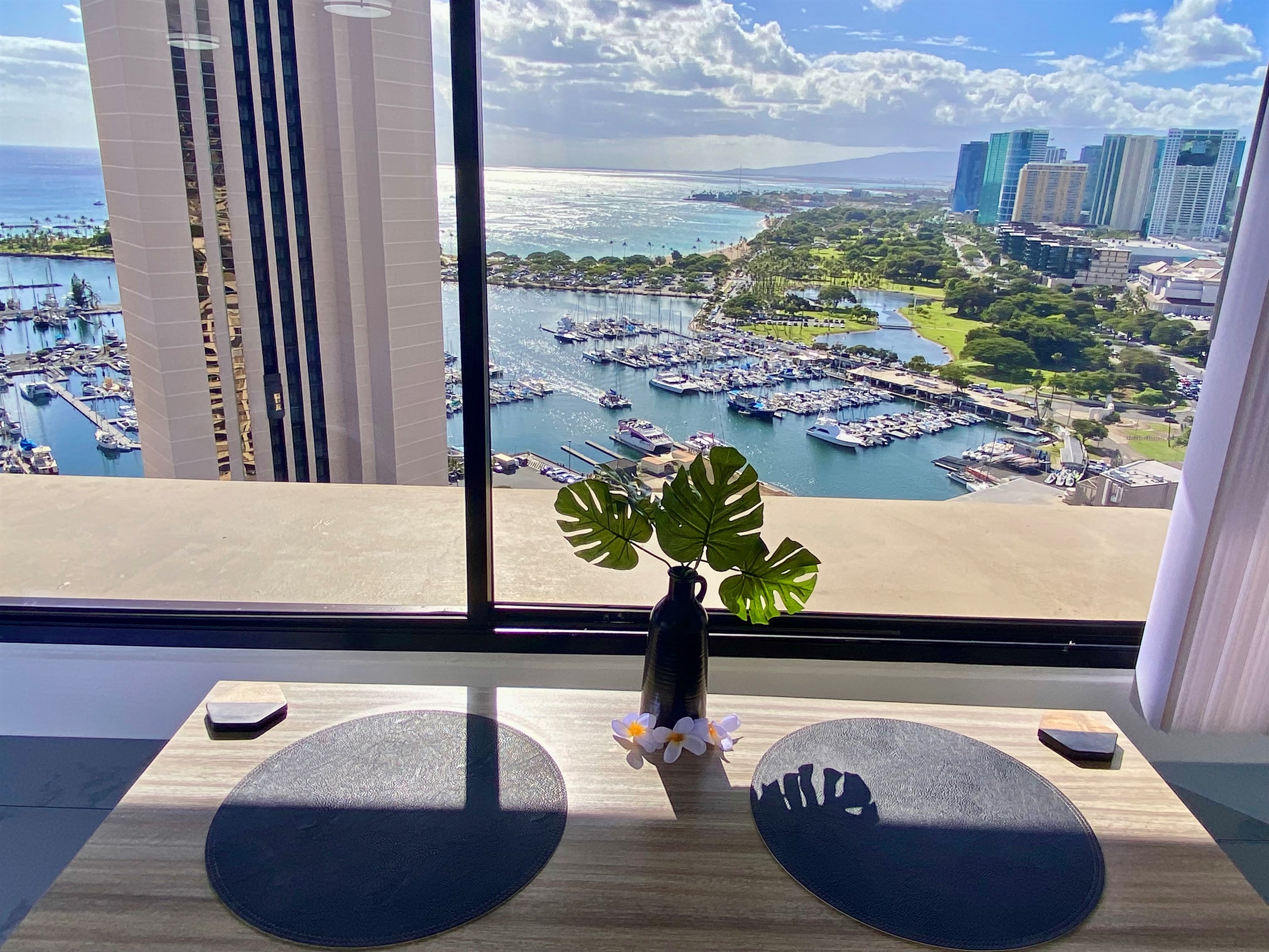 Wake up to this breathtaking view of the Ala Wai Boat Harbor and the endless Pacific horizon. Enjoy your morning coffee or evening wine while watching sailboats drift beneath the Hawaiian sun — the perfect start and finish to each day in paradise.