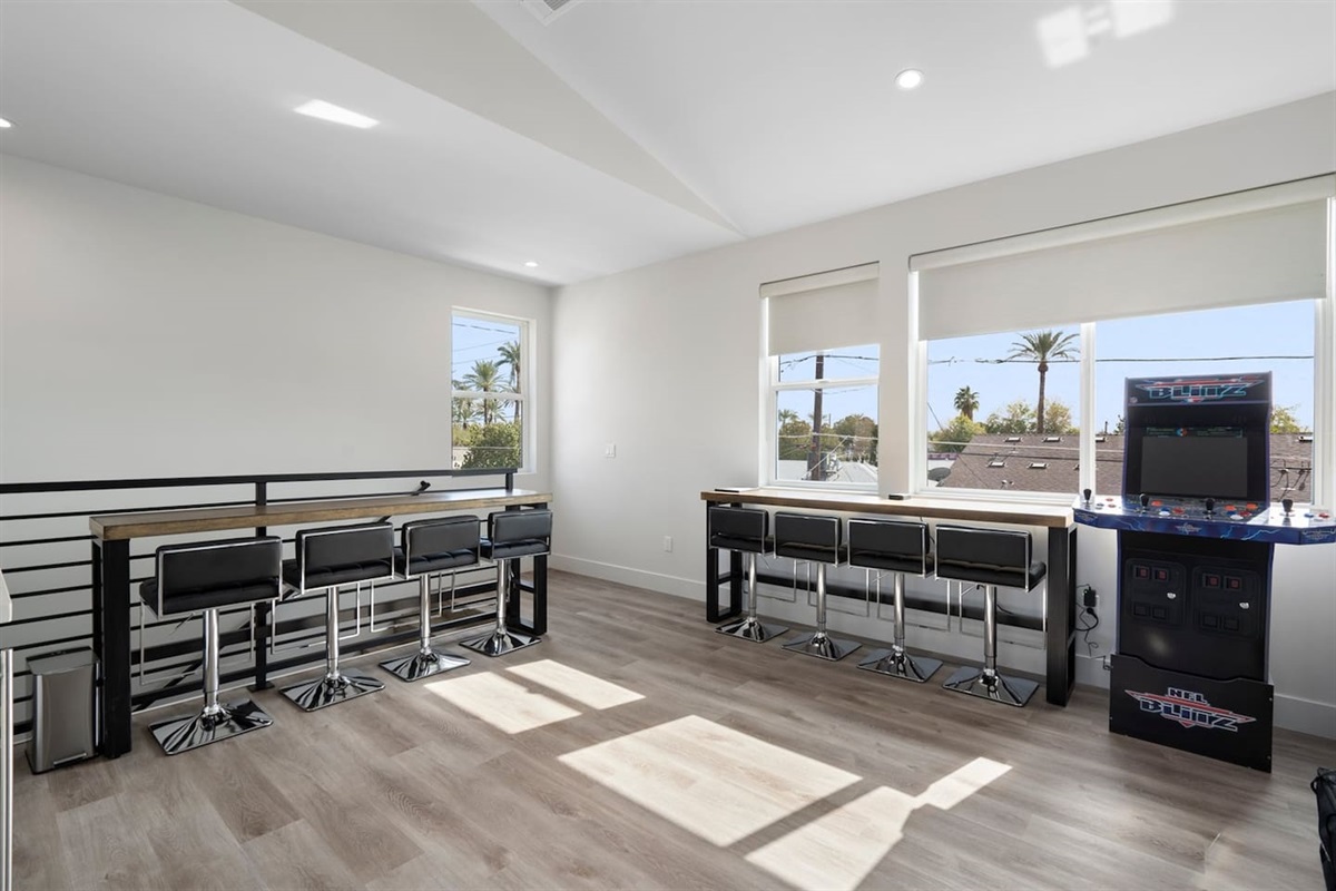 Experience convenience in the kitchenette, equipped with comfortable seating, coffee machines, and a wine cooler. Unwind with a game of blitz arcade for a touch of nostalgia and fun!