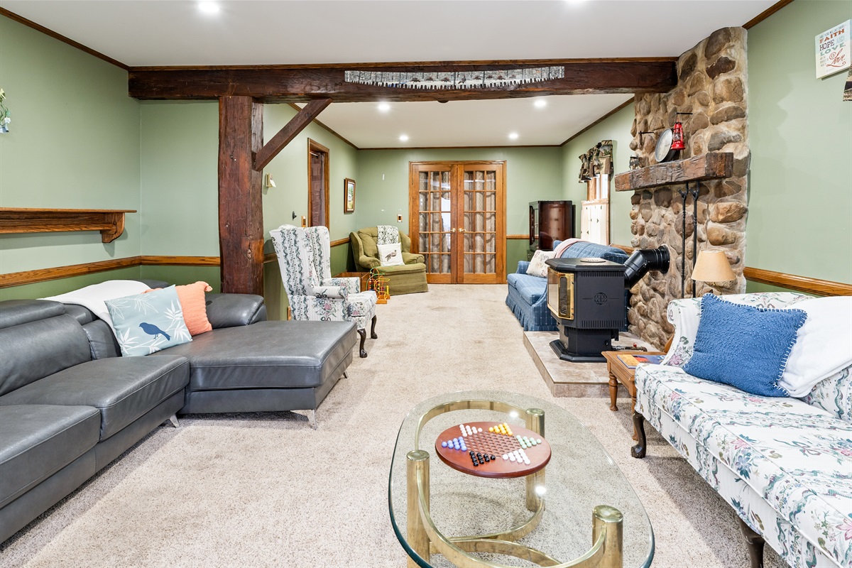 Large living area with natural light, comfy sectional, and countryside charm — an ideal place to unwind with loved ones.