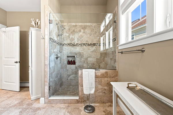 Refresh after a day at the beach in this beautifully tiled walk-in shower.