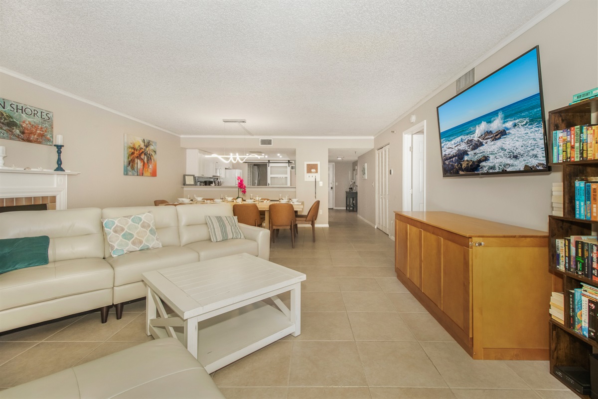 Huge open cozy living room with 70-inch LED Smart TV, Fireplace and Gulf Views