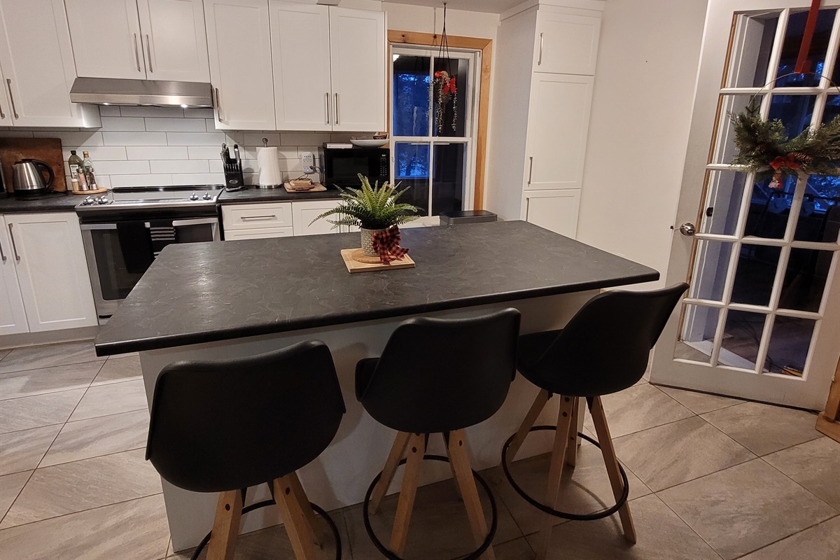 Kitchen island with view of seating and counter