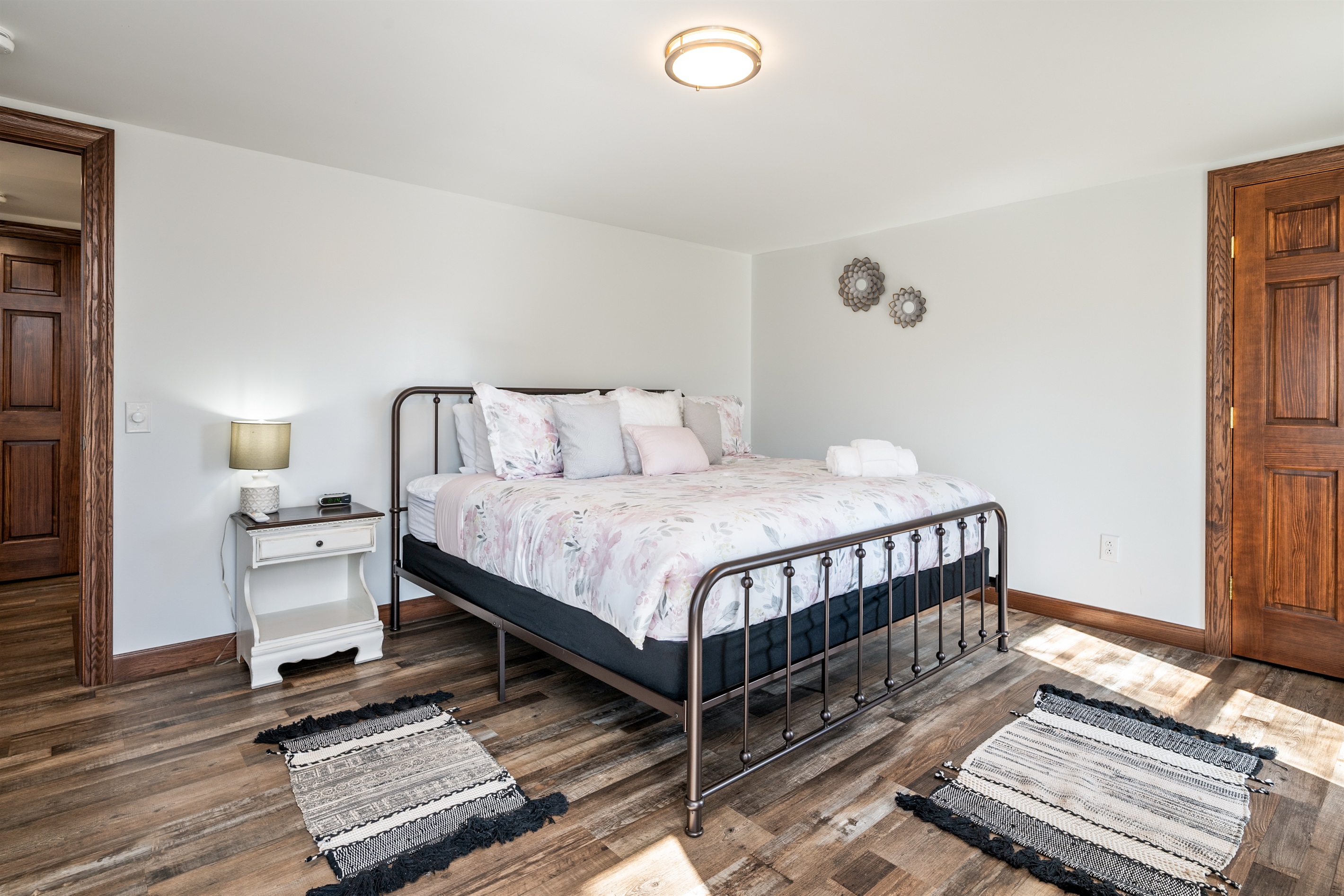Elegant bedroom with a sleek iron bedframe and soft neutral tones—blending rustic charm with modern comfort for a peaceful night’s sleep.