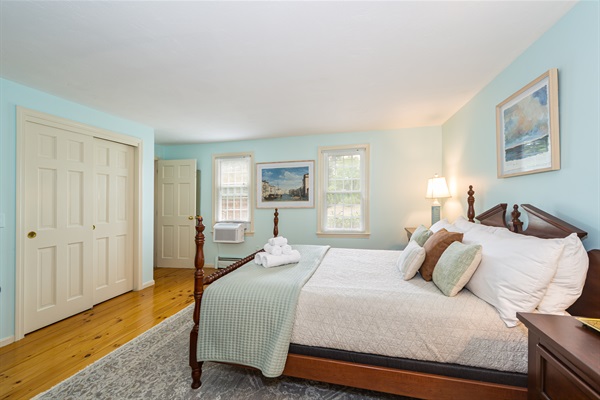 Main floor bedroom with queen bed and shared ensuite