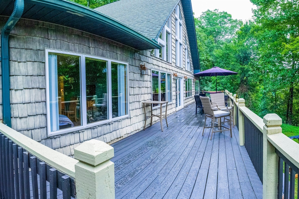 Large deck with outdoor seating, offering the perfect spot to unwind and soak up the sun! Get ready for some serious relaxation.