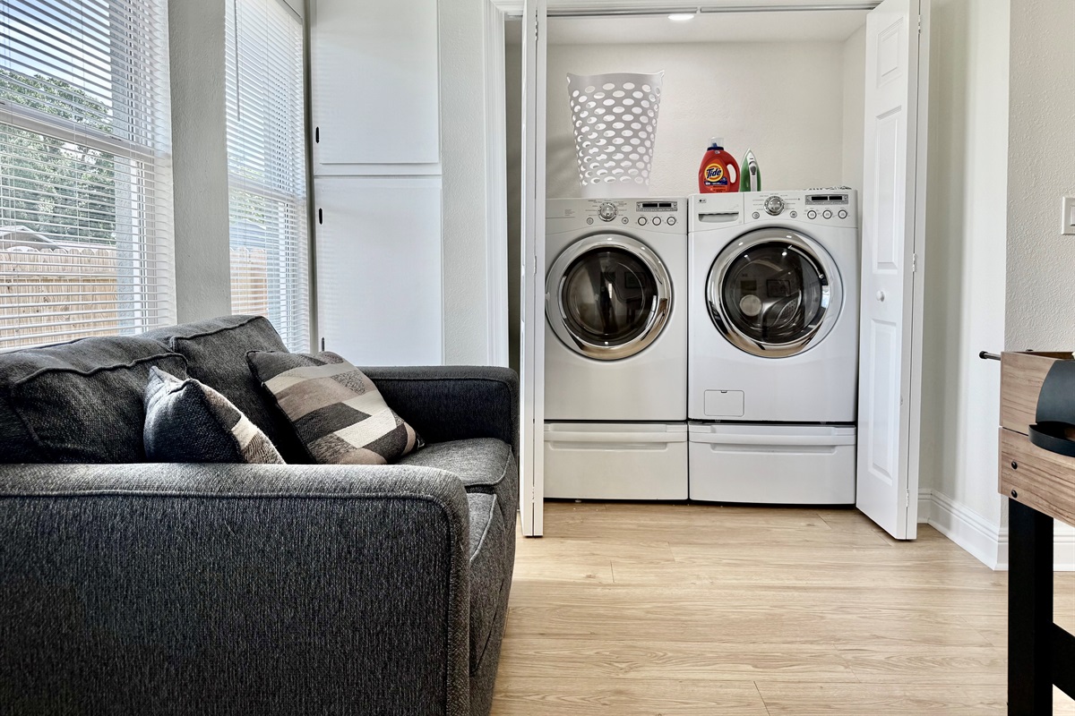 Skip the laundromat! This private laundry closet offers full-size machines, a laundry basket, and all the essentials you need—just steps from the bathroom and bedrooms.