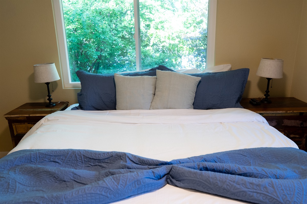 Plush bedding and garden views for a restful sleep.
