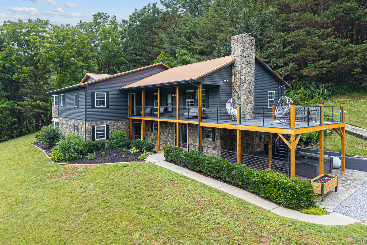Scenic retreat with stunning views, spacious deck, and charming stone accents!