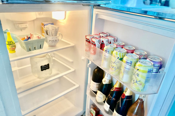 Your first bottle of wine is on us. The fridge also holds chilled reverse-osmosis water, complimentary sparkling water, creamer, milk and everyday condiments—with additional wine available at cost for easy evenings in.
