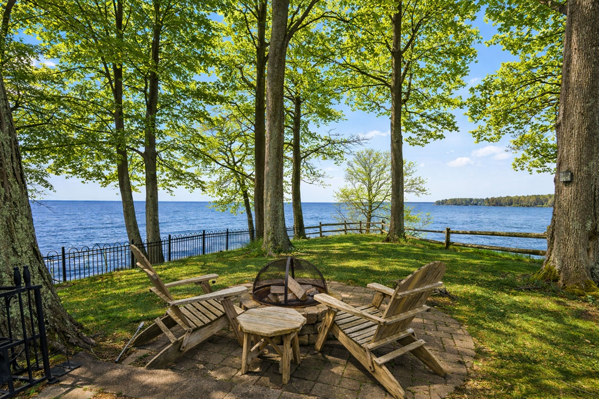 Gather around the firepit on the patio, where you can enjoy a cozy evening with a beautiful lake backdrop.